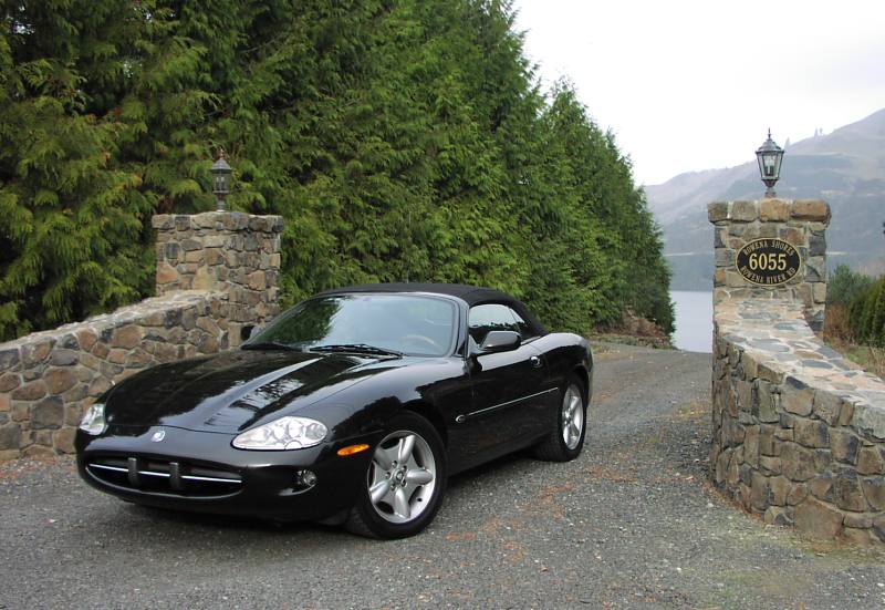 The sleek anthracite colored XK8 graces the stone gates at the entrance to our summer home.